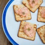 small crackers are arranged on a white plate