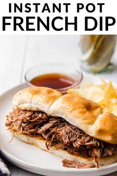 an image of french dip sandwich on a plate with potato chips and ketchup