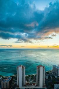 an aerial view of the ocean and buildings in miami, florida at sunset or sunrise