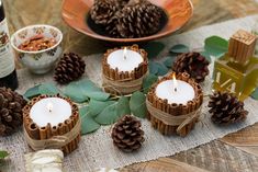 pine cones and candles sit on a table