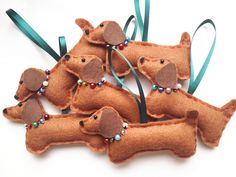 four felt dachshunds with beads on them