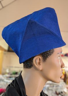 **Royal Blue Aso Oke Abeti-Aja "Akinrinola" Kufi Cap Hat by Dupsie's African Fashion** Elevate your formal or special occasion attire with the Royal Blue Aso Oke Abeti-Aja "Akinrinola" Kufi Cap Hat, exclusively designed by Dupsie's African Fashion. This exquisite African hat, steeped in rich cultural heritage, is more than just a fashion statement; it’s a celebration of Yoruba tradition and African fashion. **Historical Significance of the Abeti-Aja Hat:**The Abeti-Aja hat, known traditionally a Adjustable Blue Flat Cap, Blue Adjustable Flat Cap, Traditional Fitted Blue Hat, Blue One Size Flat Cap Baseball Cap, Blue Adjustable Costume Hats With Short Brim, Adjustable Blue Costume Hats With Curved Brim, Traditional Blue Cap, Adjustable Blue Cap Costume Hats And Headpieces, Blue Adjustable Cap-style Costume Hats