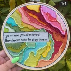 someone is holding up a colorful hand embroidery art piece that says, go where you're loved, then learn how to stay there