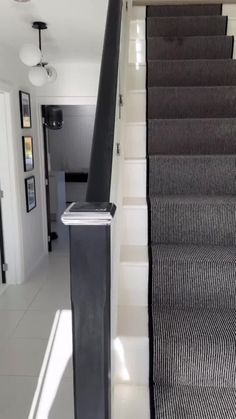 the stairs are lined with black and white carpet