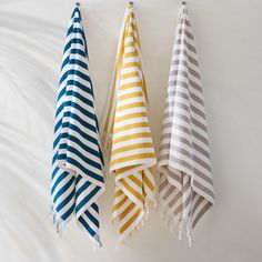 three striped towels hanging on the wall