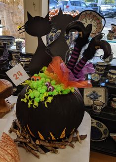 a decorated pumpkin sitting on top of a table