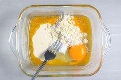 eggs and flour in a glass bowl with a fork