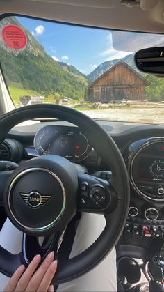 the interior of a car with steering wheel, dashboard and gauges in front of it