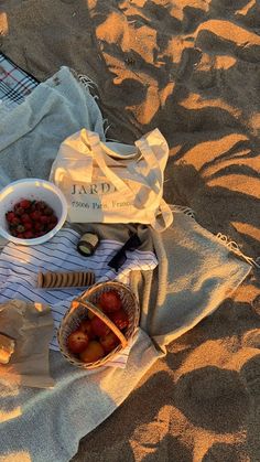 a picnic on the beach with fruit and crackers