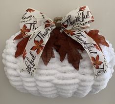 a white basket with autumn leaves and ribbons on it that says, thank you all