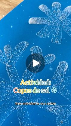 a blue box with snowflakes on it and the words actividad copos de sal