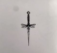 a black and white photo of a dragonfly flying in the sky with a diamond on it's tail