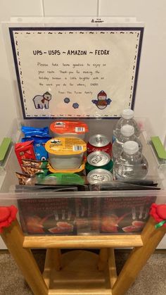 an open box with food in it sitting on top of a wooden table next to a sign