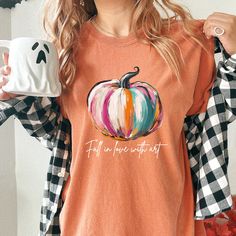 Searching for the perfect Fall Pumpkin Shirt Woman Comfort Colors, Cute Pumpkin TShirt for Fall in Love with Art Shirt, or Autumn Vibes Shirt for Halloween for Teen Girl; then look no further! -PRODUCT DESCRIPTION- Celebrate the beauty of autumn with this artistic "Fall Pumpkin Shirt." Featuring a hand-painted-style pumpkin and the inspiring message "Fall in Love with Art," this tee is perfect for those who appreciate creativity and the changing seasons. Crafted with Comfort Colors' soft-washed, garment-dyed fabric, this shirt offers both comfort and durability. Its relaxed fit and medium fabric weight make it ideal for casual outings, fall festivals, or cozy evenings spent enjoying the crisp autumn air. Made from 100% ring-spun US cotton, this tee is both comfortable and environmentally f Pumpkin Tshirt, Fall Festivals, Inspiring Message, Crisp Autumn, Art Shirt, Pumpkin Shirt, Autumn Vibes, Cute Pumpkin, Fall Festival