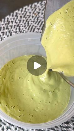 a bowl filled with yellow liquid on top of a table