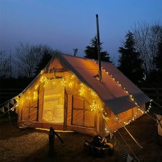 a tent is lit up with fairy lights