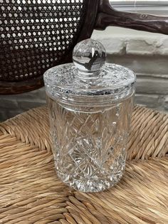 a glass jar sitting on top of a wicker chair