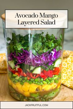 a mason jar filled with vegetables and lettuce