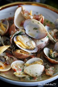 a bowl filled with clams and other seafood