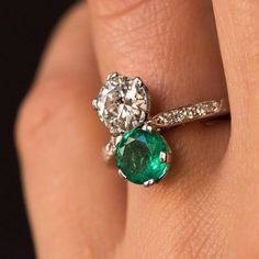 This is part of Chairish’s Fine Jewelry assortment.  Ring in platinum, dog's head hallmark.  Called "you and me", this ring is set with a brilliant- cut diamond and a round emerald.  On both sides, on the departure of the ring is set a line of diamonds 8/8 cut.  A spring ring, currently present on the ring may, if necessary, be removed.  Total weight of the emerald: 1.18 carat approximately.  Total weight of main diamond: 1.06 carat approximately.  Height: 14.8 mm, width: 7.5 mm, thickness: 5.4 Diamond White Emerald Ring With Round Cut, Gia Certified Round Cut Gemstones For Anniversary, Gia Certified Gemstones For Anniversary, Emerald Gemstones With Center Stone In Round Cut, Round Cut Emerald Gemstone With Center Stone, Anniversary Diamond Gemstone For May Birthstone, Green Brilliant Cut Diamond Gemstones, Round Cut Emerald Diamond Ring, Vvs Clarity Emerald Gemstones For Anniversary