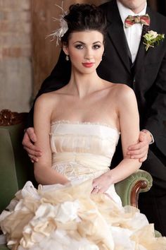 a man in a tuxedo standing next to a woman in a wedding dress