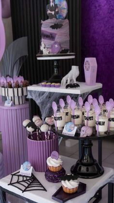 a table topped with lots of cupcakes and cakes