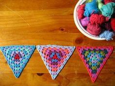 crocheted triangle buntings on a wooden table