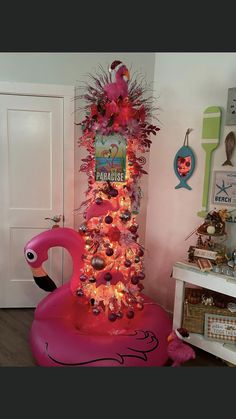 a pink flamingo christmas tree with decorations