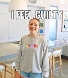 a woman standing in front of a table with chairs and a sign that says, i feel guilt