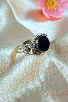 Sanskrit for divine, Divya symbolizes the life energy within us which connects to the divine energy of the universe. Our Divya ring is handcrafted in fine sterling silver, with signature textured detailing and an authentic large solitaire gemstone as a centerpiece, adding sophistication to your everyday look. Authentic Sivalya Black Onyx Hallmarked Metal: 925 Sterling Silver Gemstone Size: 10mm x 10mm Cut: Round Shaped Smooth Cabochon Black Onyx: Endurance, Perseverance, Grounding Black Spiritual Round Rings, Symbolic Black Gemstone Jewelry, Symbolic Black Oval Jewelry, Traditional Black Jewelry With Polished Finish, Traditional Black Sterling Silver Rings, Symbolic Black Rings With Oxidized Finish, Black Spiritual Jewelry With Oxidized Finish, Spiritual Black Jewelry With Oxidized Finish, Spiritual Onyx Ring Jewelry