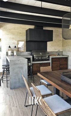 an open kitchen and dining area with wood flooring