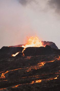 there is a fire burning on the top of a mountain