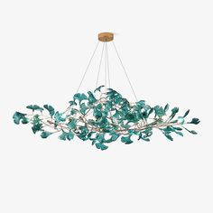 a chandelier with green leaves hanging from it's center and light fixture