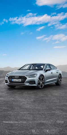 an audi car parked in the middle of a desert