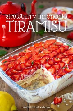 strawberry limoo trifle in a glass casserole dish on a wooden table