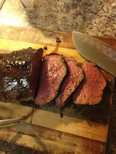 a steak on a cutting board with a knife