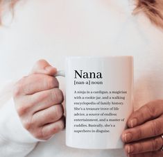 a woman holding a coffee mug with the words nana on it