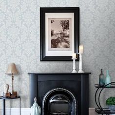 a living room with a fire place and pictures on the fireplace mantels in front of it