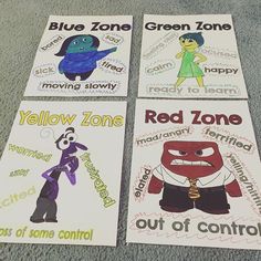 four posters with different words on them sitting on the floor in front of a carpet