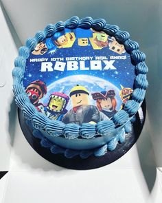 a birthday cake with the name roblox on it in front of a box