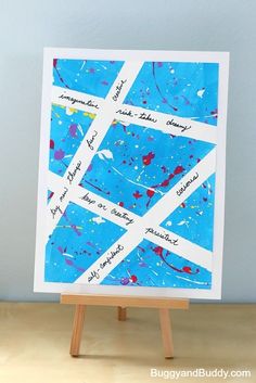 a blue and white painting on an easel with words written in different languages,