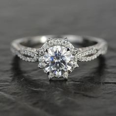 a white gold engagement ring with an oval cut diamond surrounded by pave set diamonds