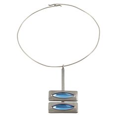 Danish jewelry artist Jorgen Jensen designed this elegant Space Age modernist collar pendant-necklace. The piece is all made in pewter with arctic blue poured glass cabochons. The artist's signature is at the back and reads Pewter - Jorgen Jensen - Denmark. The necklace is in good condition, with minor wear on the metal. Measurements: The collar circumference is 16.13 in (41 cm) - The pendant is 3.13 in high (7.9 cm) x 1.69 in wide (4.2 cm) - The necklace will fit a Small to Medium size neck. No Antique Choker, Gold Collar Necklace, Beautiful Chokers, Jewelry Artist, Arctic Blue, Choker Pendant, Pewter Metal, Vintage Wardrobe, Contemporary Pendant