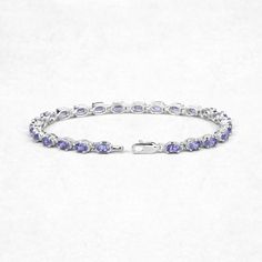 6.25 Carat Genuine Tanzanite .925 Sterling Silver Bracelet Product Details: Metal: .925 Sterling Silver Setting: prongs Item: Bracelet Finish: Rhodium Plated Metal Stamp: 925 QJ™ IN Total CTW: 6.25 Carat Length 7.50 inches Width 4.06 MM Height 4.06 MM Weight: 9.05 Grams Chain Type: No Chain Type Clasp Type: Single Strand Fishhook Gemstone Information: Tanzanite Quantity: 25/6.25 ctw Shape / Size: Oval/5x3mm Classic Oval Gemstone Tennis Bracelet, Classic Sterling Silver Gemstone Bracelet, Classic Round Sterling Silver Bracelet With Gemstone, Classic Sterling Silver Bracelet With Gemstone, Oval Link Gemstone Bracelets For Anniversary, Oval Gemstone Bracelets For Anniversary, Classic Sterling Silver Oval Gemstone Bracelet, Classic Sterling Silver Bracelet With Oval Gemstone, Classic Oval Gemstone Sterling Silver Bracelet