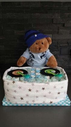 a teddy bear sitting on top of a cake