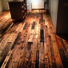 an empty room with wood flooring in it