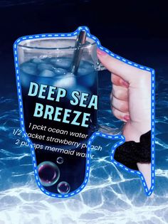 a hand holding a drink in the water with an advertise for deep sea breeze