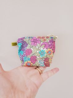 "100% Cotton. Lightweight. From the world famous Liberty Fabrics with a silk-like touch, unique print quality and striking color vibrancy. This mini pouch is great size for a couple of small items. Size is 4\"W / 3\"H / 1.5\"D (10cm / 8cm / 4cm) Flat bottom shape. Fabric is Liberty of London Tana Lawn. The pouch opens with golden color zipper.(High quality YKK zipper) It comes with a velvet ribbon on one side. Lined inside with pretty baby-pink color cotton. Please, Hand wash. Or cool brilliantl Mini Zipper Pouch, Pouch Makeup, Fabric Pouch, Baby Pink Colour, Cute Wallets, Mini Pouches, Pretty Prints, Toiletry Storage, Liberty Of London