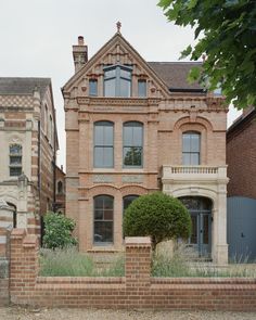 an old brick house with two story windows