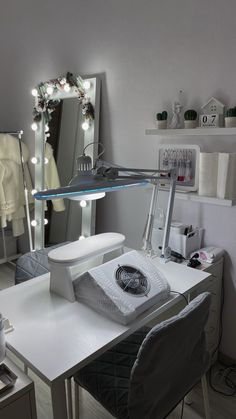 a white desk topped with a mirror and a hair dryer